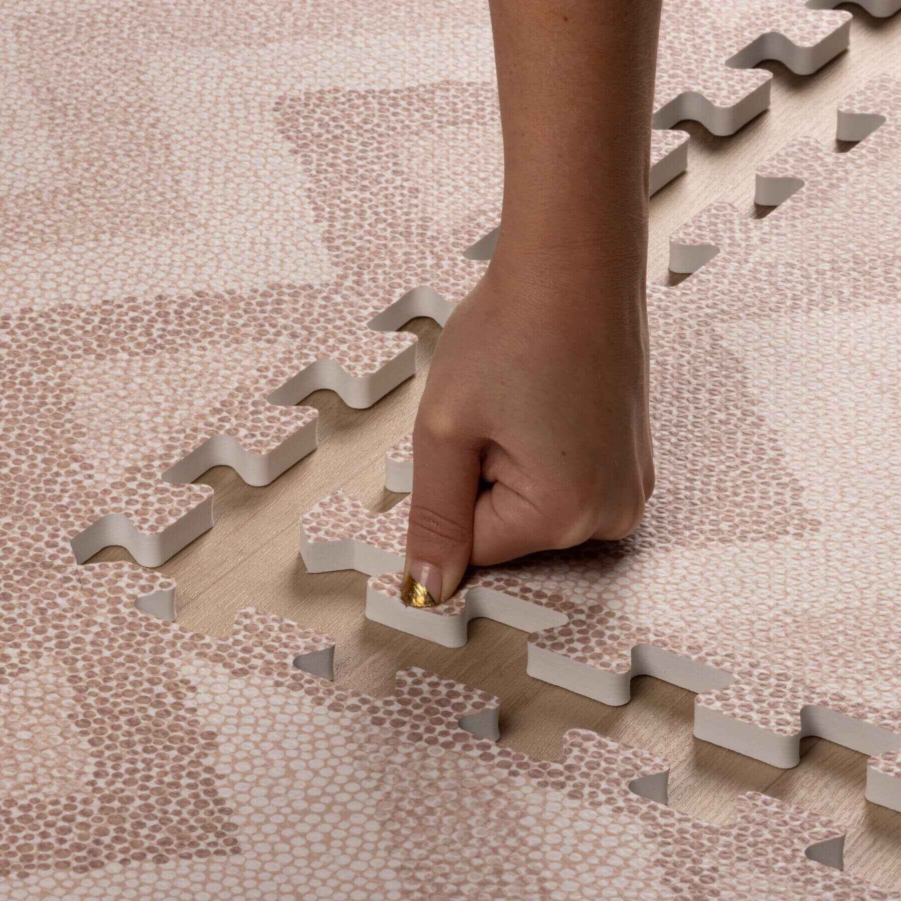 Hand placing on Eeveve Kilim Play Mat - Warm Pink