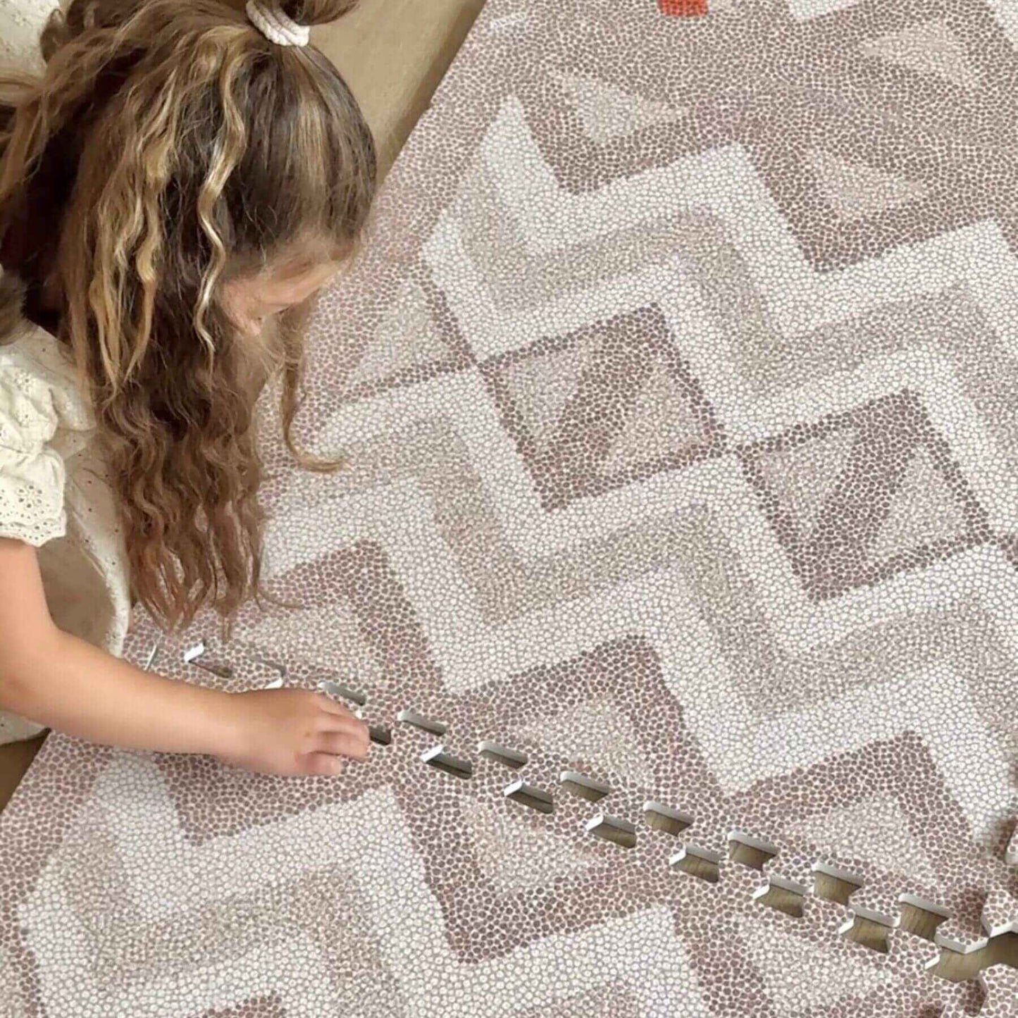 Child playing with Eeveve Kilim Play Mat - Warm Pink