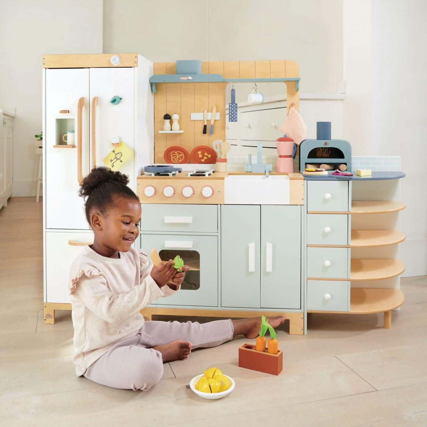 Child playing with Tender Leaf La Fiamma Grand Kitchen in a bright room
