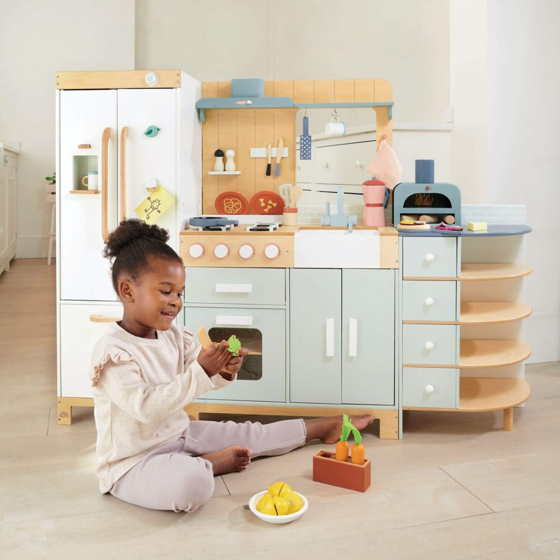 Child playing with Tender Leaf La Fiamma Grand Kitchen in a bright room