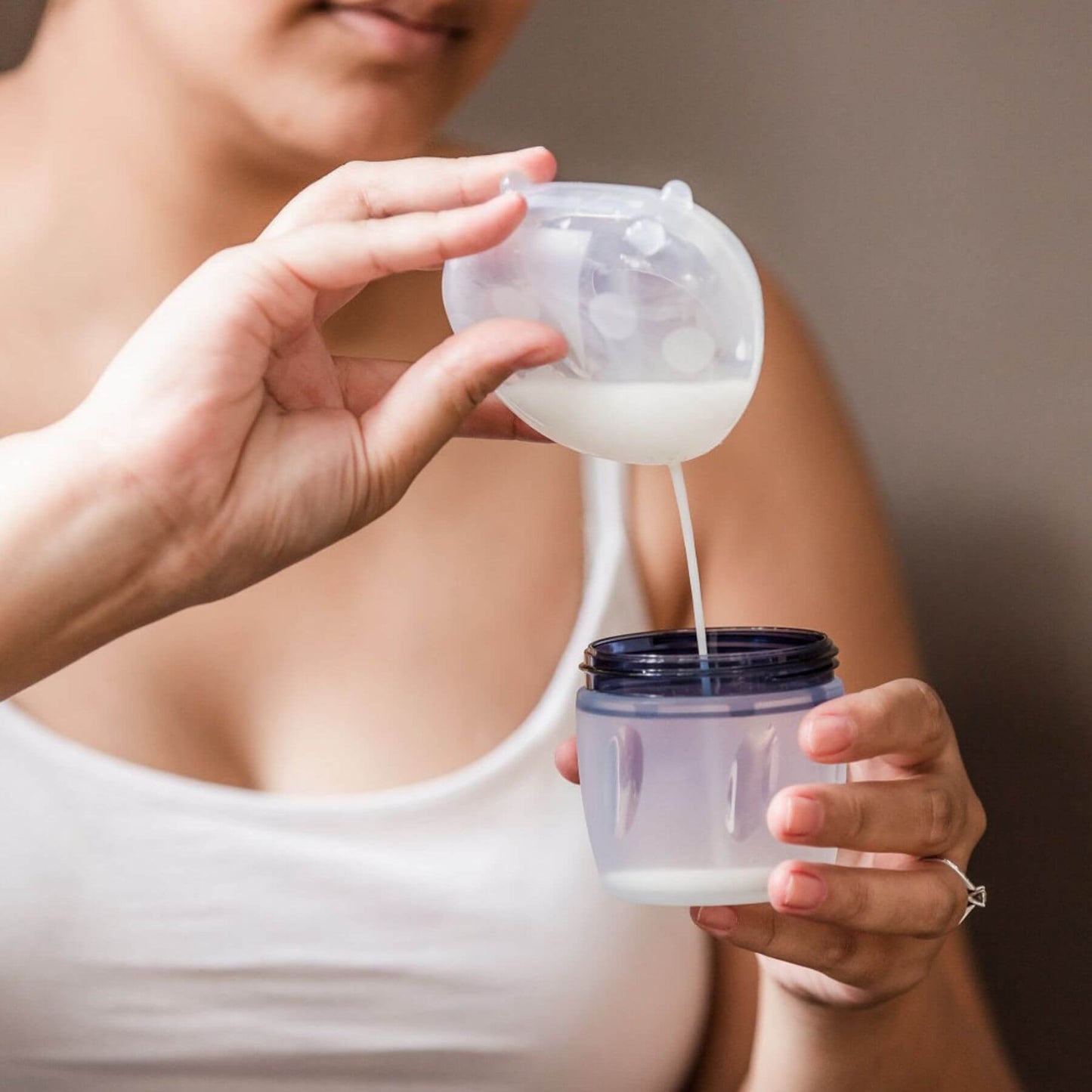 Person using Haakaa Ladybug Silicone Milk Collector to collect milk.