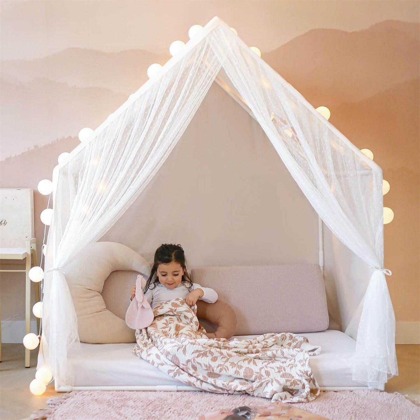 Girl Sitting on the Bed inside Tiny Land® Large Space Play House with Star Lights