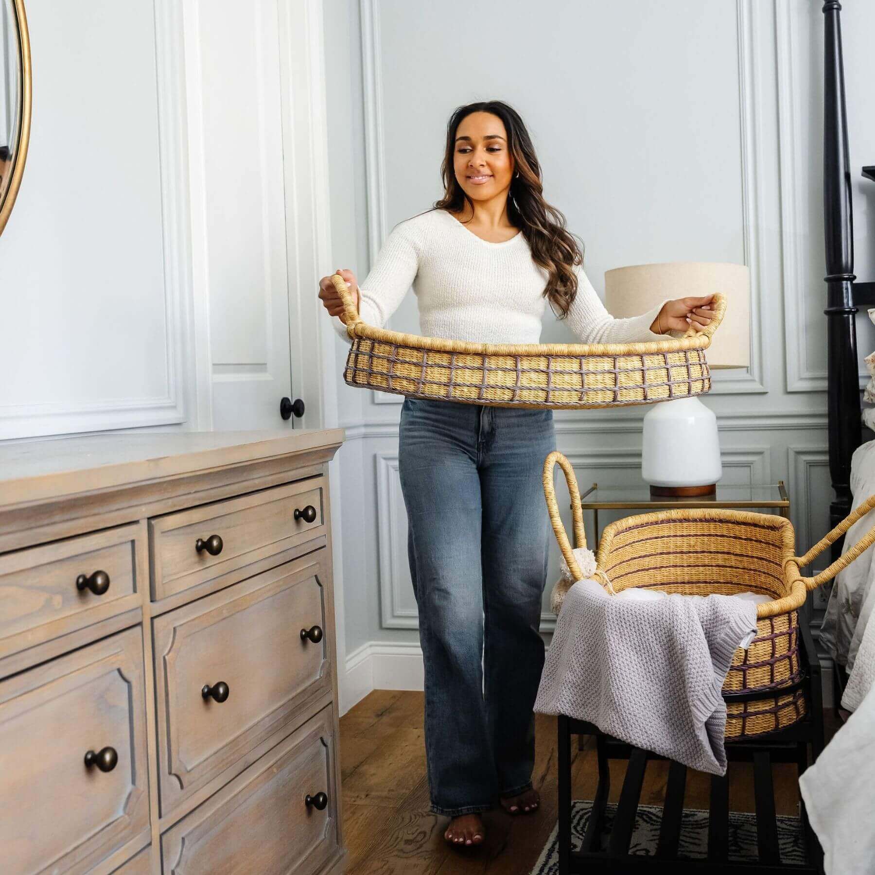 Woman holding Lavender Grid African Moses Basket Vegan Handle in a bedroom setting