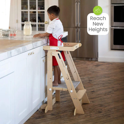 Boy Standing on Little Partners Learn 'N Fold Learning Tower Natural near Kitchen Tower