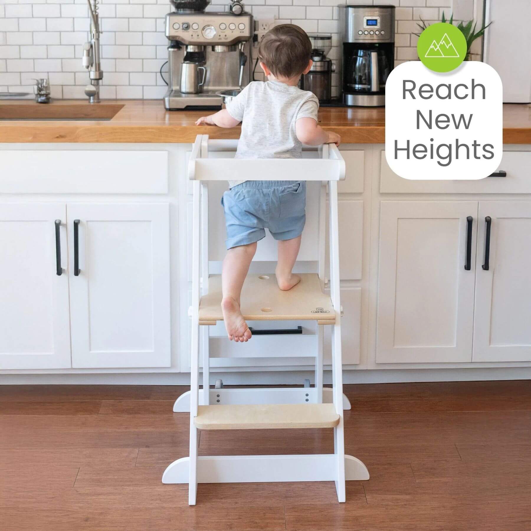 Boy Standing on Little Partners Learn 'N Fold Learning Tower Natural & White