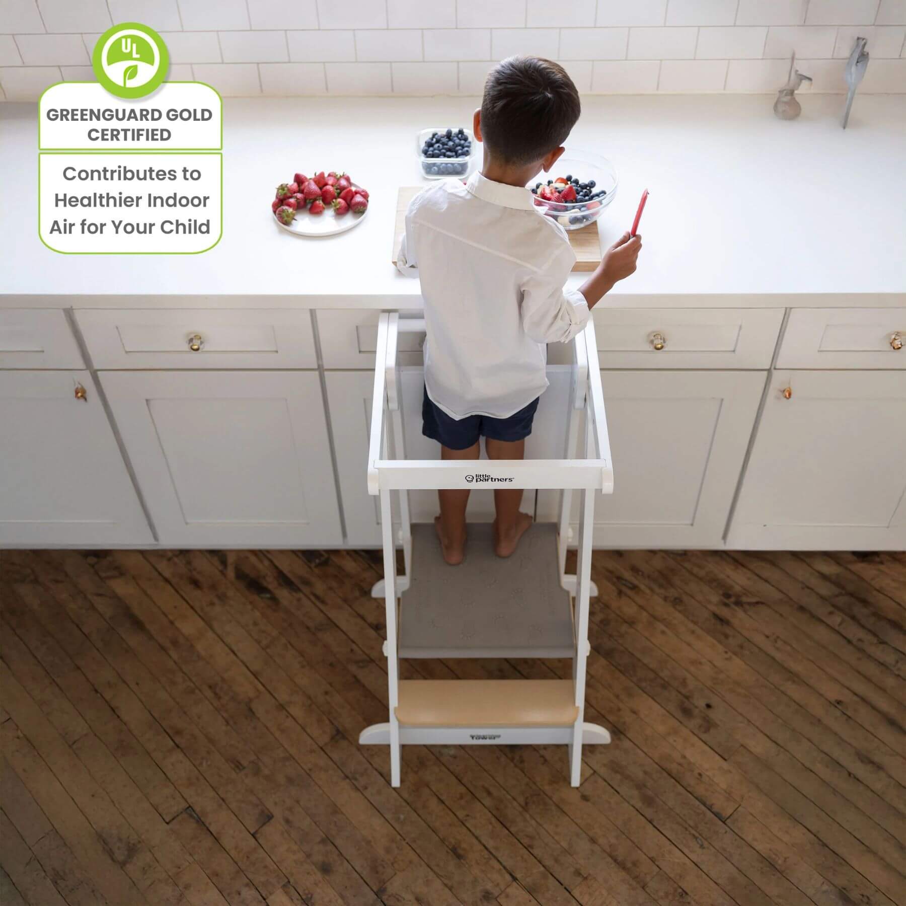 Boy Standing on Little Partners Learn 'N Fold Learning Tower Natural & White, Cutting Fruits