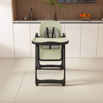 Leavader Adjustable Baby High Chair - Dark Green in a kitchen setting with cabinets and a countertop in the background.