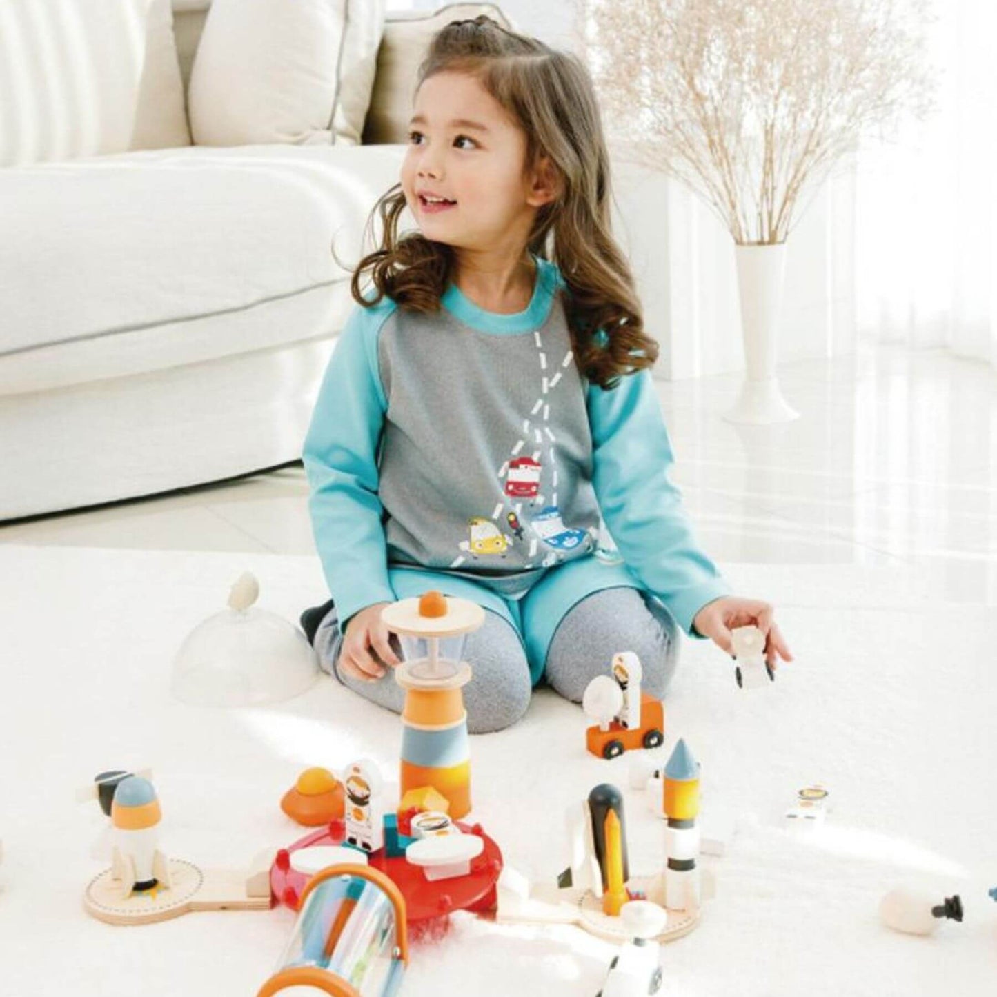 Child playing with Tender Leaf Life on Mars Set on a white floor with a neutral-colored couch in the background