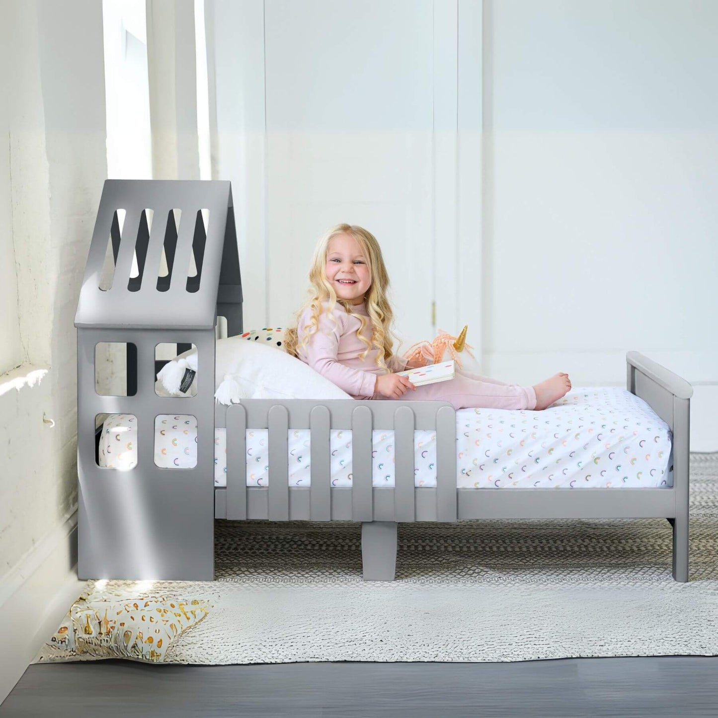 Girl Sitting on Little Partners Lil' House Toddler Bed Silver Drop