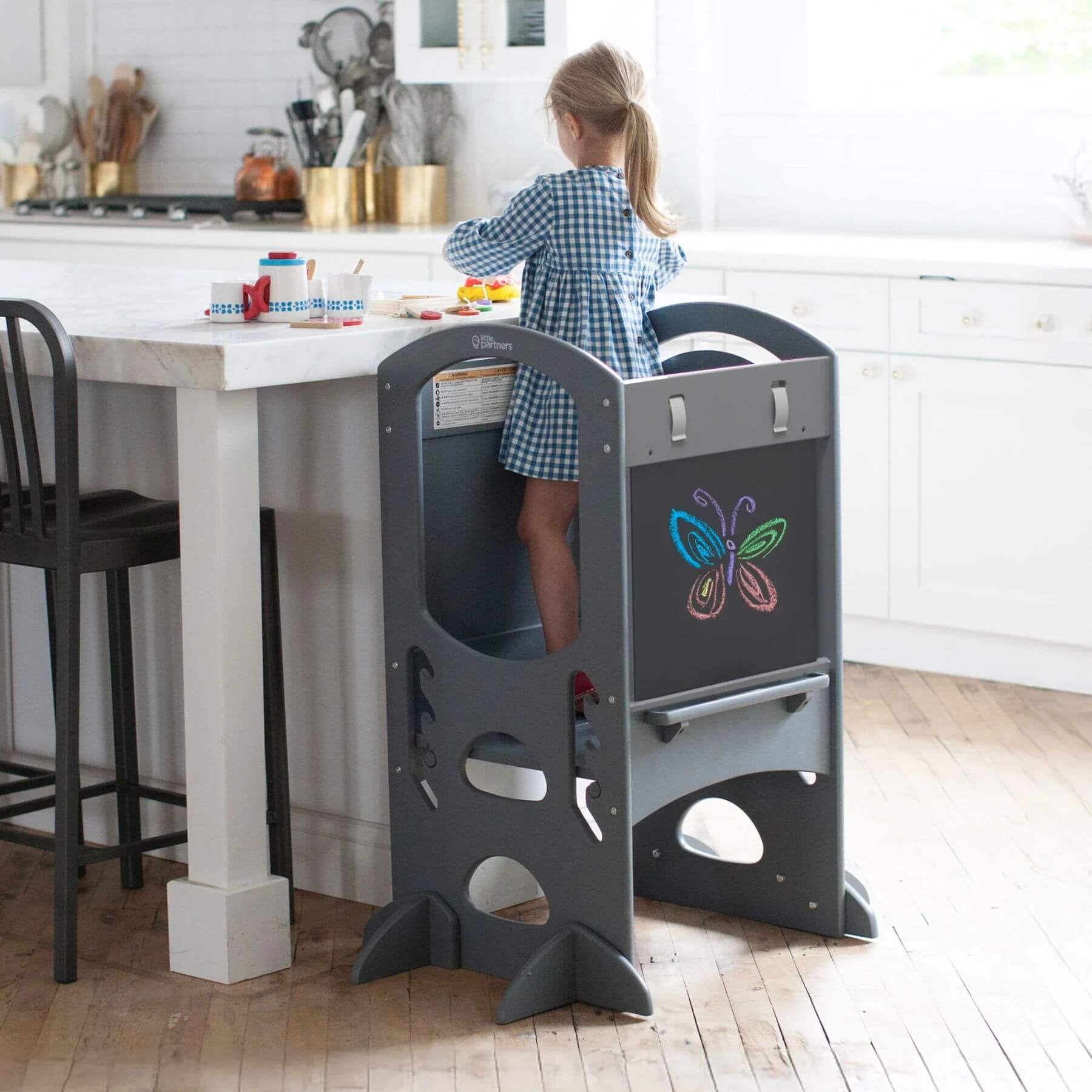 Girl Standing on Little Partners Limited Edition Learning Tower Grey, Playing
