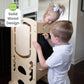 Boy Drawing on the Blackboard on Little Partners Limited Edition Learning Tower Natural