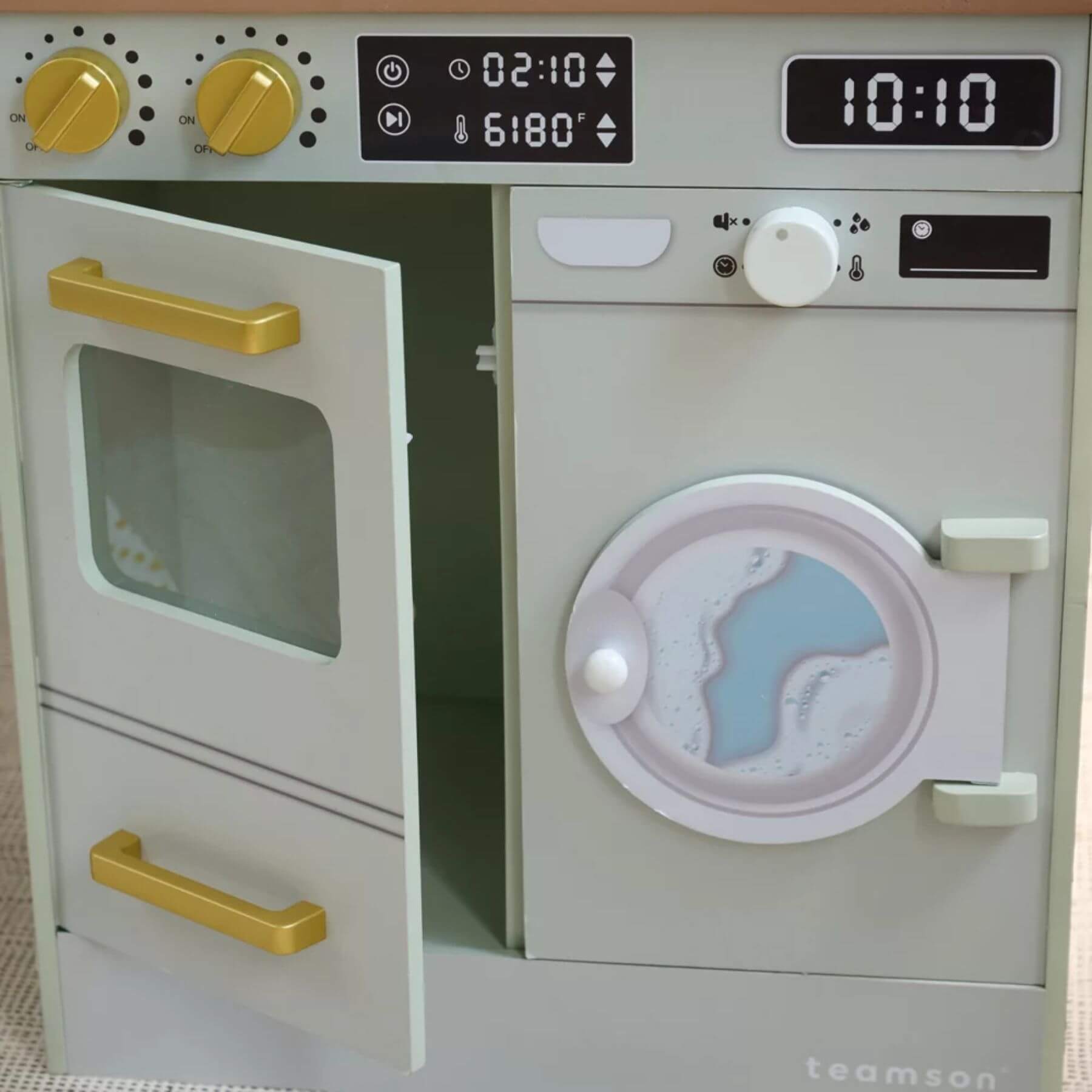 Toy kitchen set with oven and washing machine, featuring digital displays and knobs.