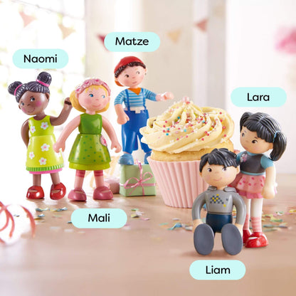 Toy figures of children around a large cupcake with names above each figure.