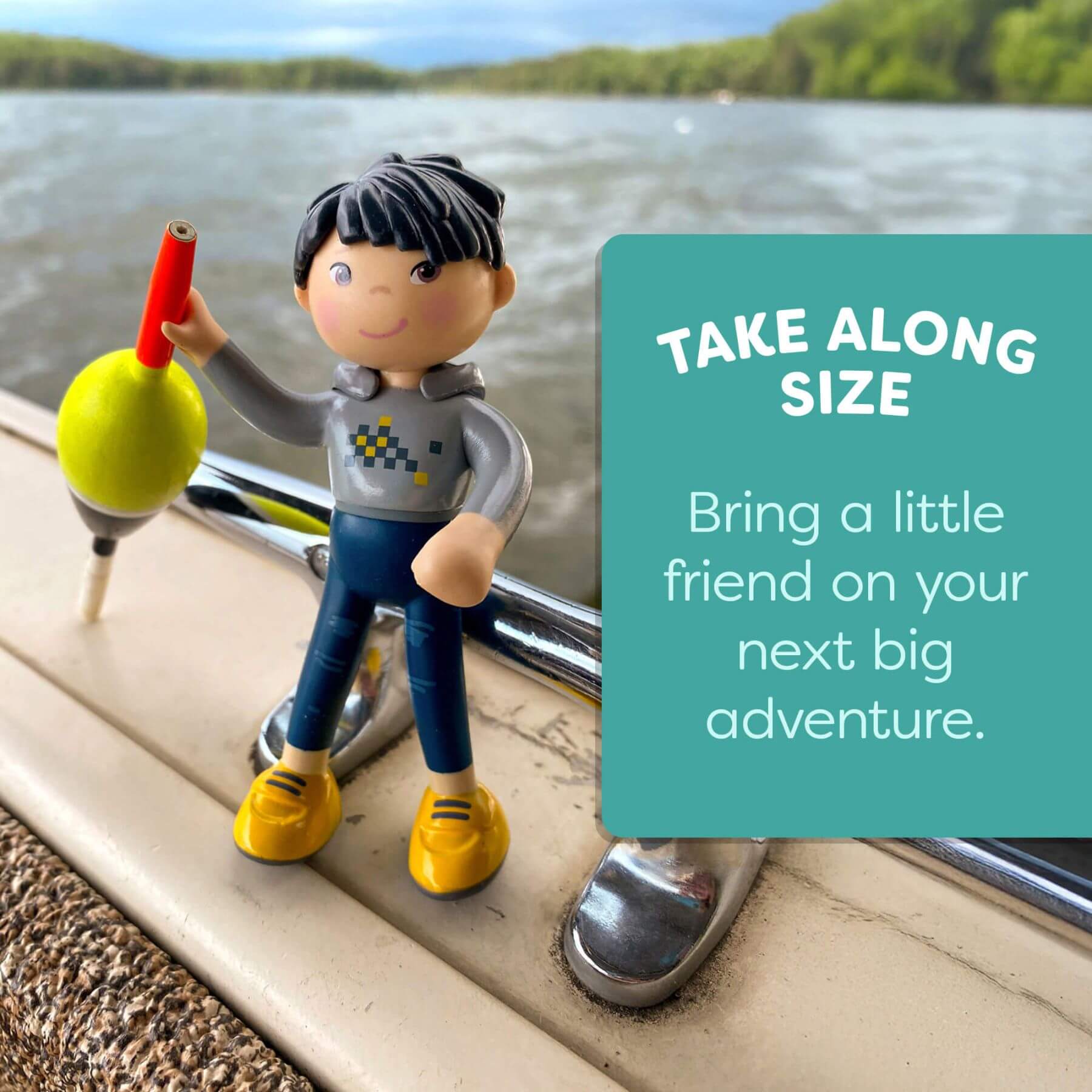 Toy figure with a red and yellow object on a car window, with text 'Take Along Size' and 'Bring a little friend on your next big adventure.'.