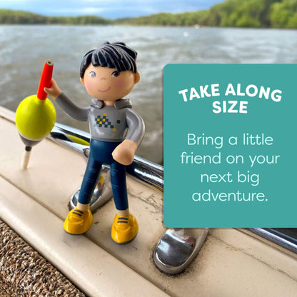 Toy figure with a red and yellow object on a car window, with text 'Take Along Size' and 'Bring a little friend on your next big adventure.'.