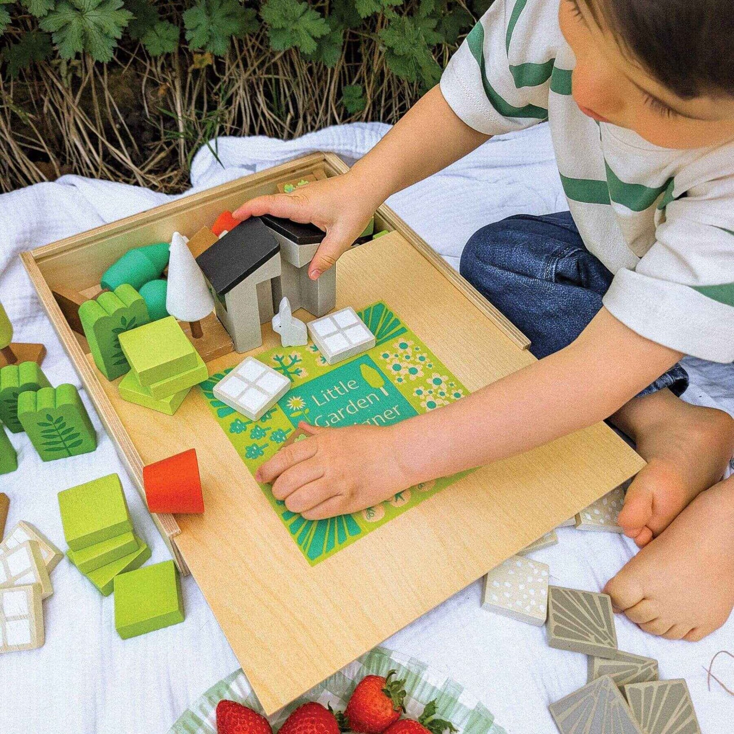 Child playing with Tender Leaf Little Garden Designer outdoors