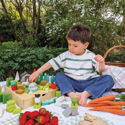 Child playing with Tender Leaf Little Garden Designer outdoors