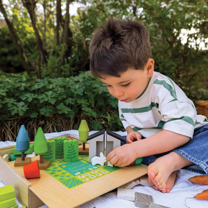 Child playing with Tender Leaf Little Garden Designer outdoors