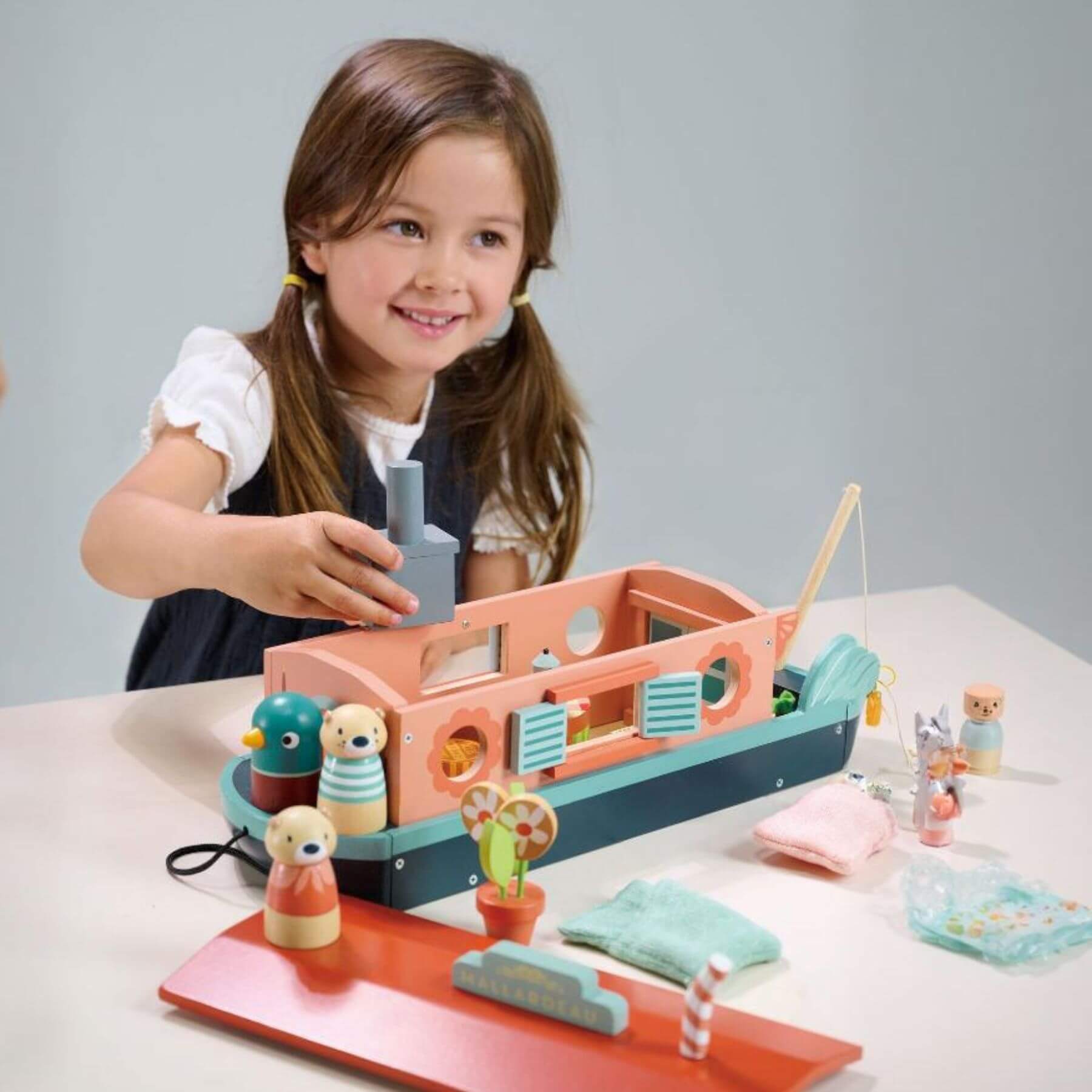 Child playing Tender Leaf Little Otter Canal Boat on a table