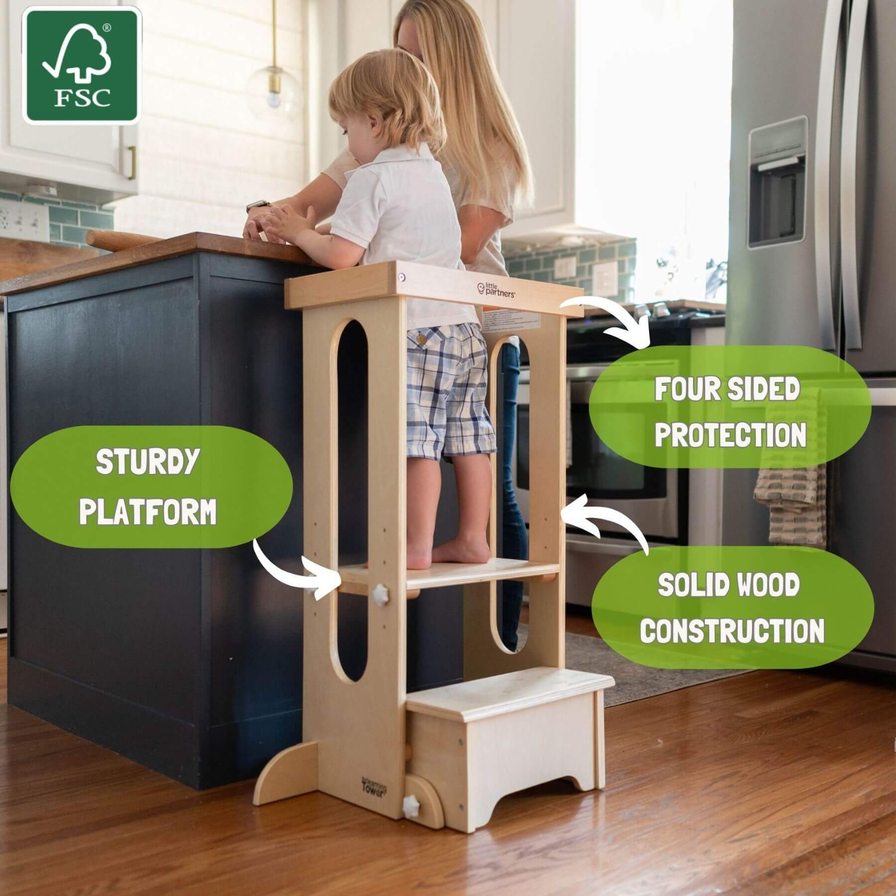 Boy Standing on Little Partners Explore 'N Store Learning Tower Natural next to Kitchen Counter