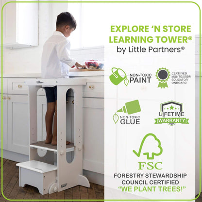Boy Standing on Little Partners Explore 'N Store Learning Tower White, cutting fruits