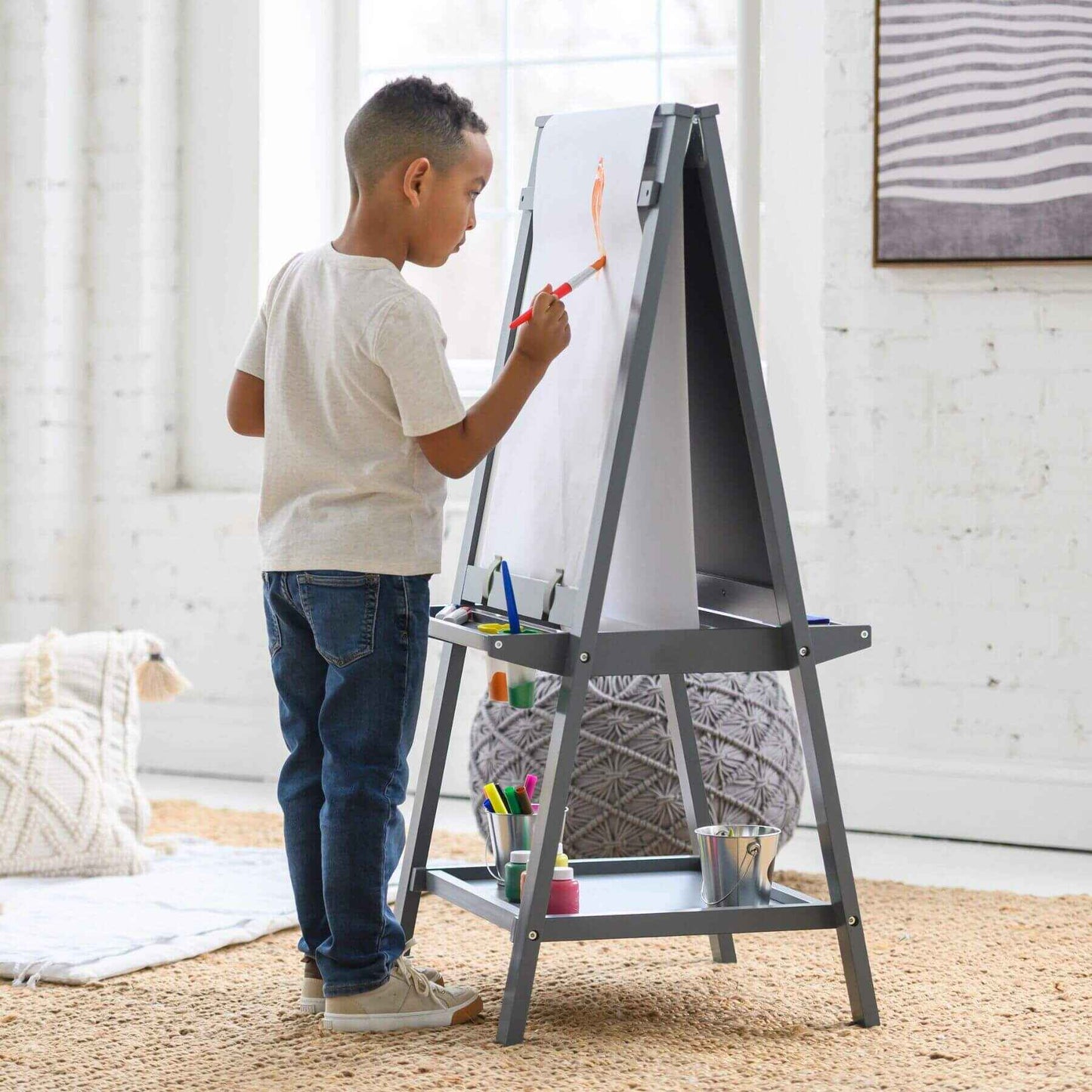 Child painting on a Little Partners Folding Artist EZ Easel Grey in a bright room