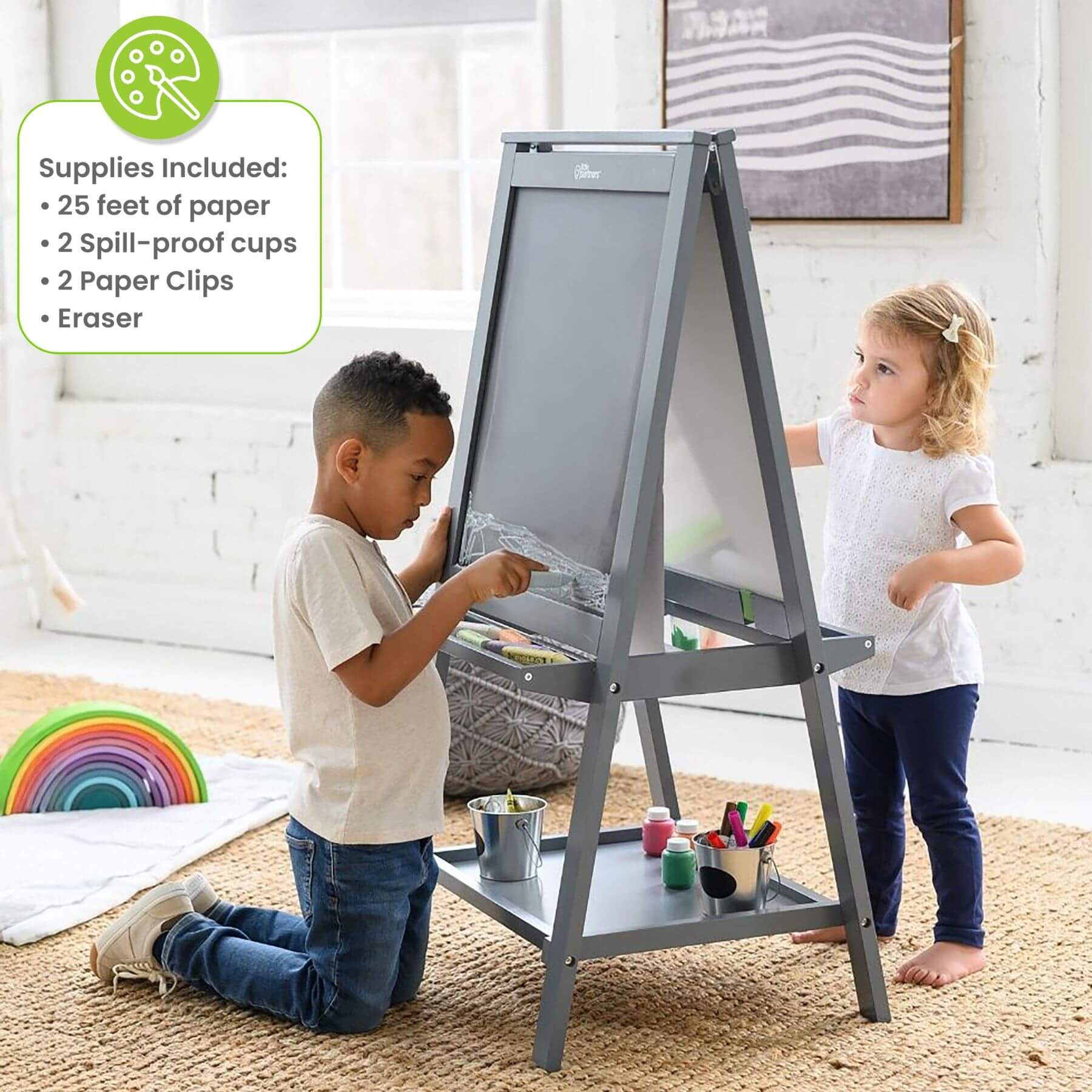 Two children using a Little Partners Folding Artist EZ Easel Grey with art supplies in a home setting.