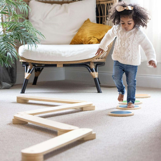Child playing with Little Partners Learn 'N Balance Set in a home setting