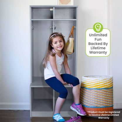 Child sitting on Little Partners Learn 'N Store Cubby Grey with a basket and bag, and a warranty badge in the corner.