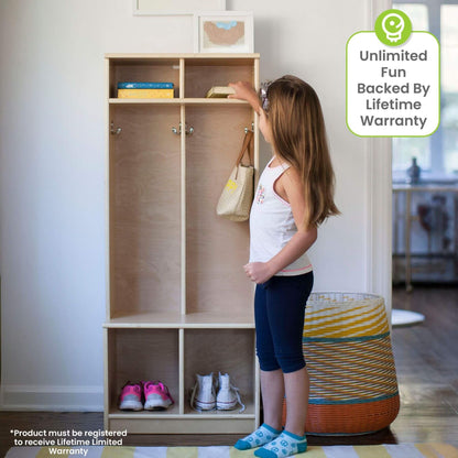 Child interacting with a Little Partners Learn 'N Store Cubby Natural in a room with a basket and shoes.