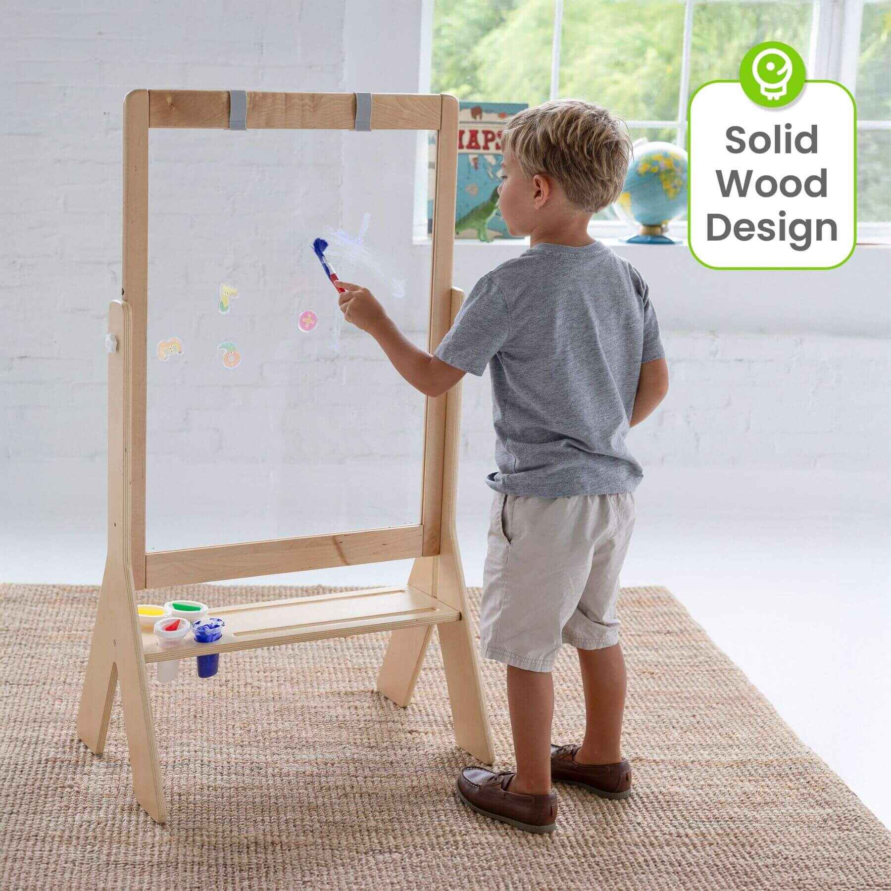 Boy Drawing on Little Partners Peek-A-Boo Easel Natural