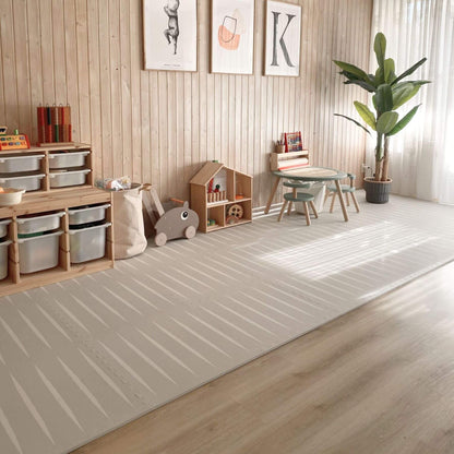 Modern living room with Eeveve Lucio Play Mat - Linen, furniture, and decor on a wooden floor.