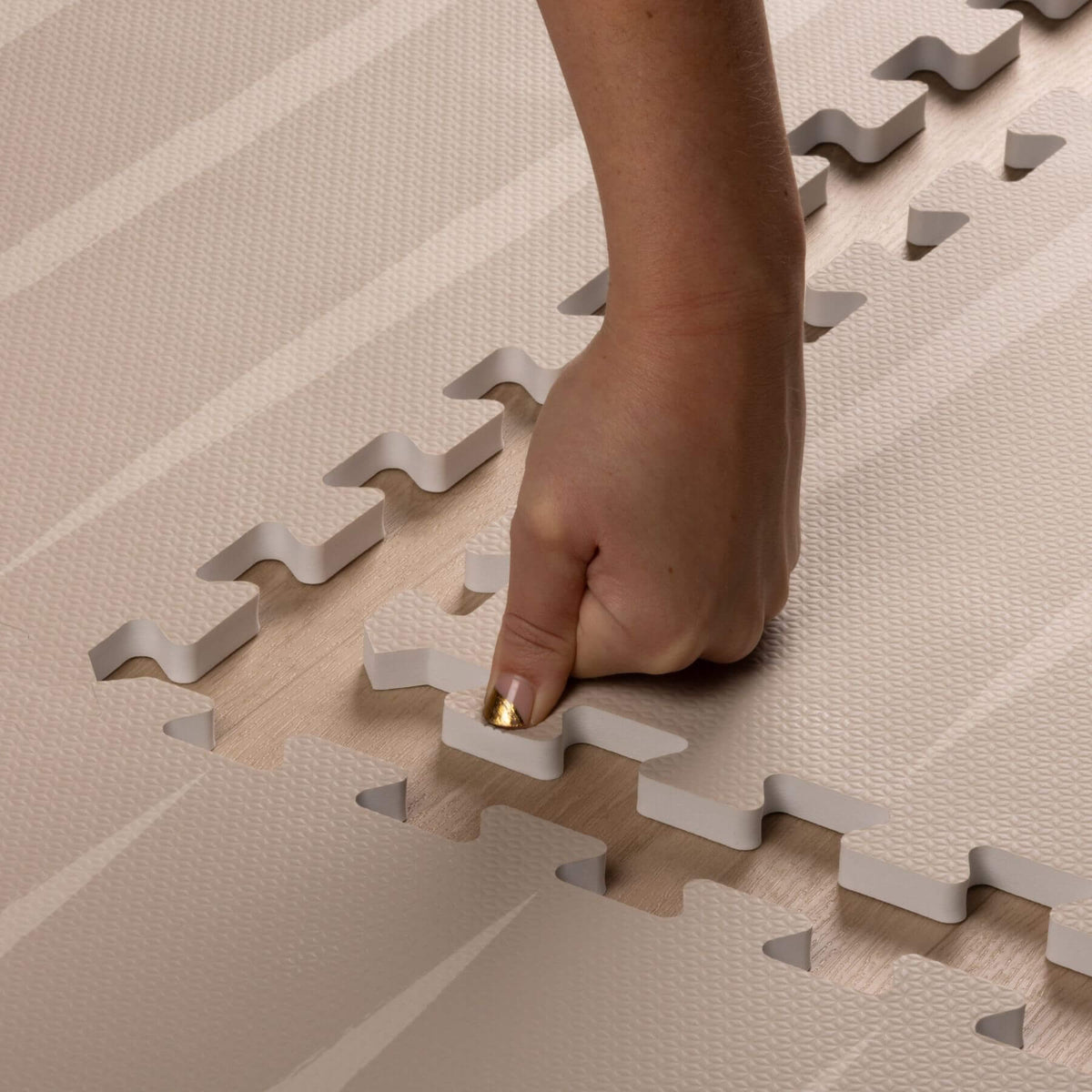 Hand placing Eeveve Lucio Play Mat - Linen