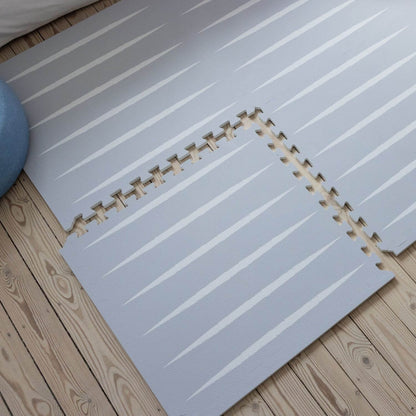 Lucio Play Mat Nordic Mist on a wooden floor
