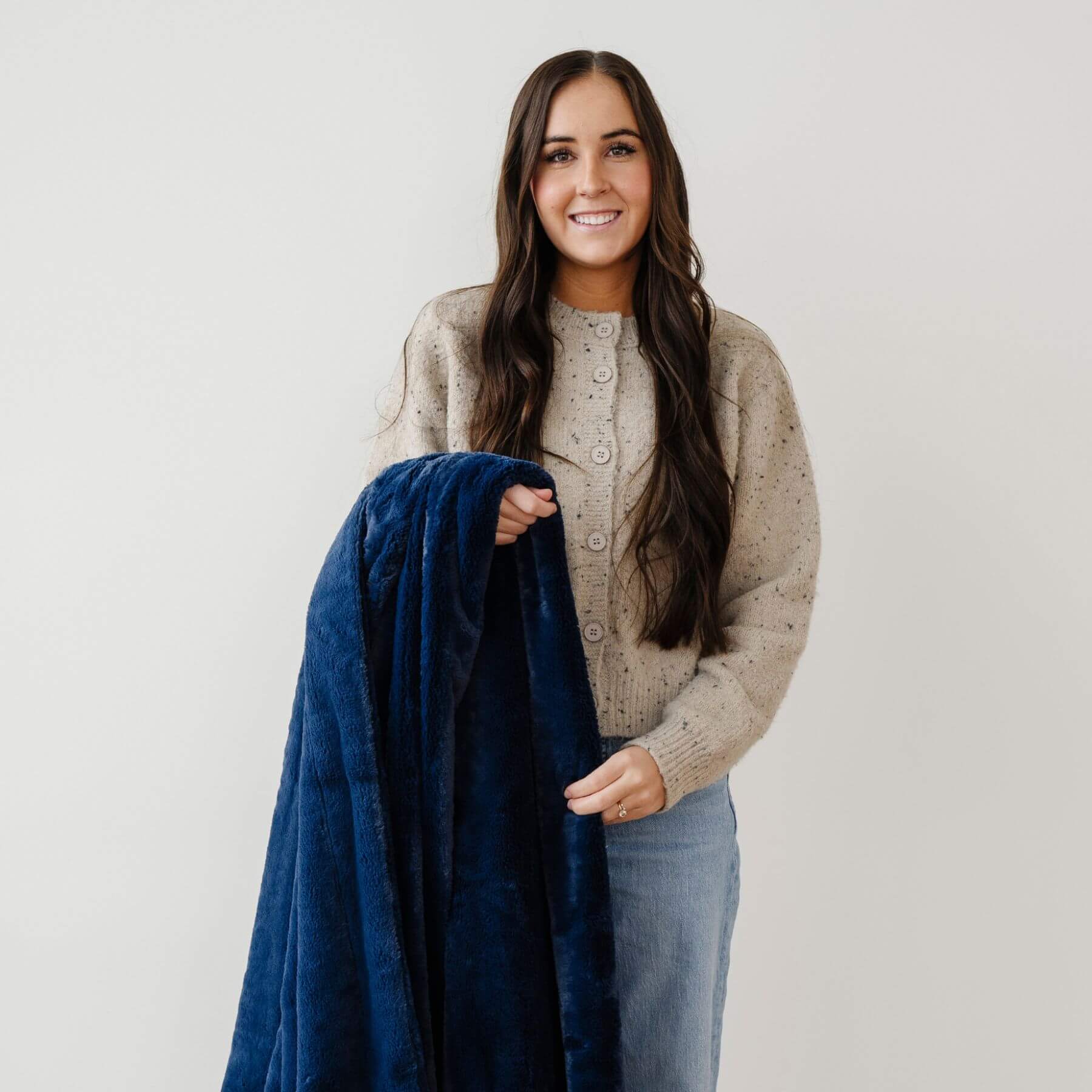 Woman holding a Saranoni Lush Throw Blanket Twilight