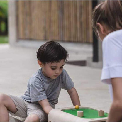 Two children playing with PlanToys Magnetic Board Game on a patio.