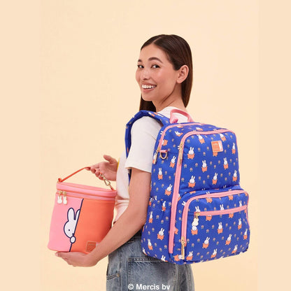 Woman wearing Miffy Flower Fields Zealous Diaper Bag Backpack - Blue & Orange