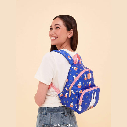 A woman wearing Miffy Flower Fields Everyday Mini Backpack - Blue & Orange