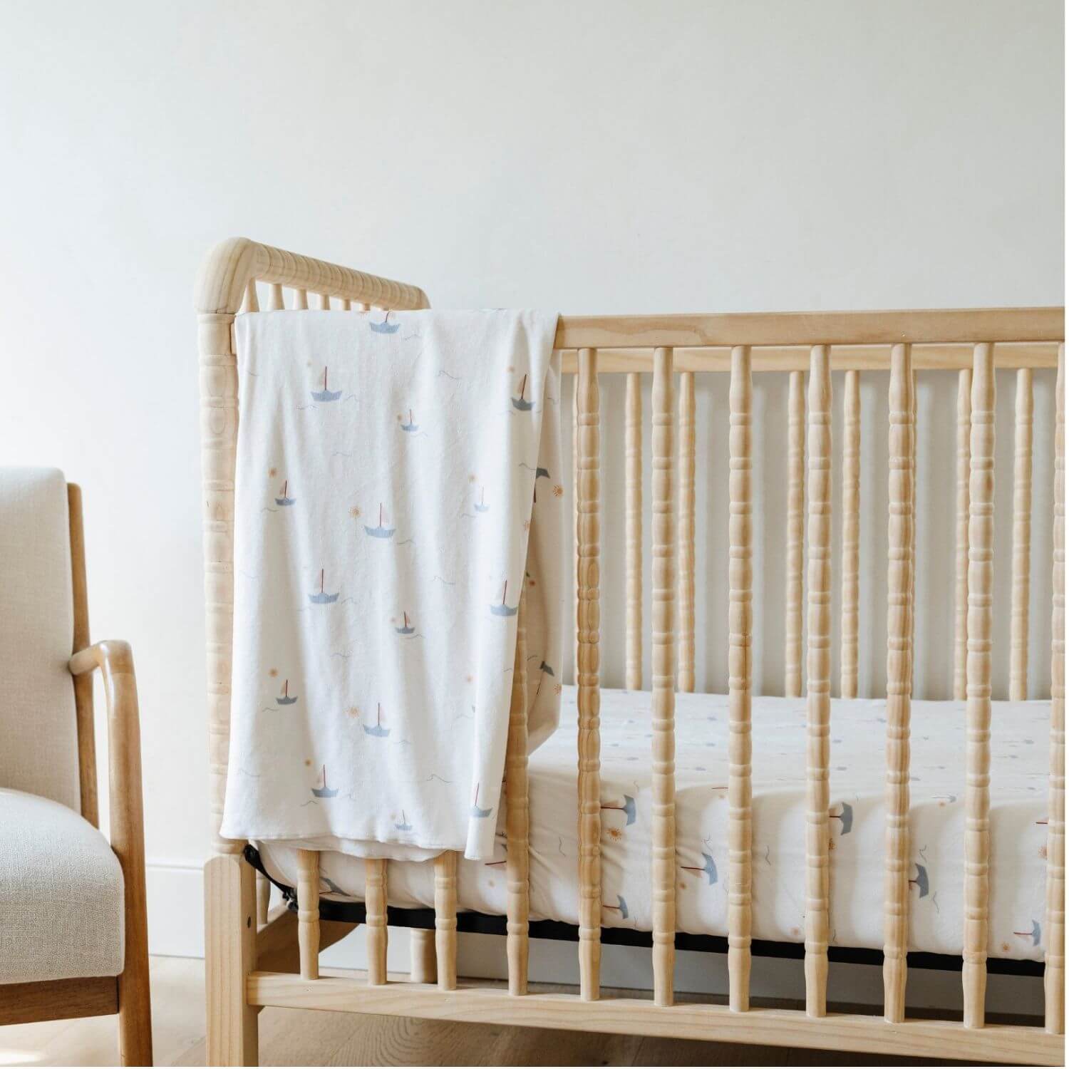 Saranoni Minky Stretch Luxe Crib Sheet Sail Boat hanging on wooden crib