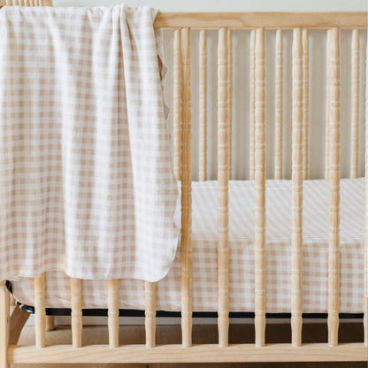 Saranoni Minky Stretch Luxe Crib Sheet Gingham hanging on wooden crib