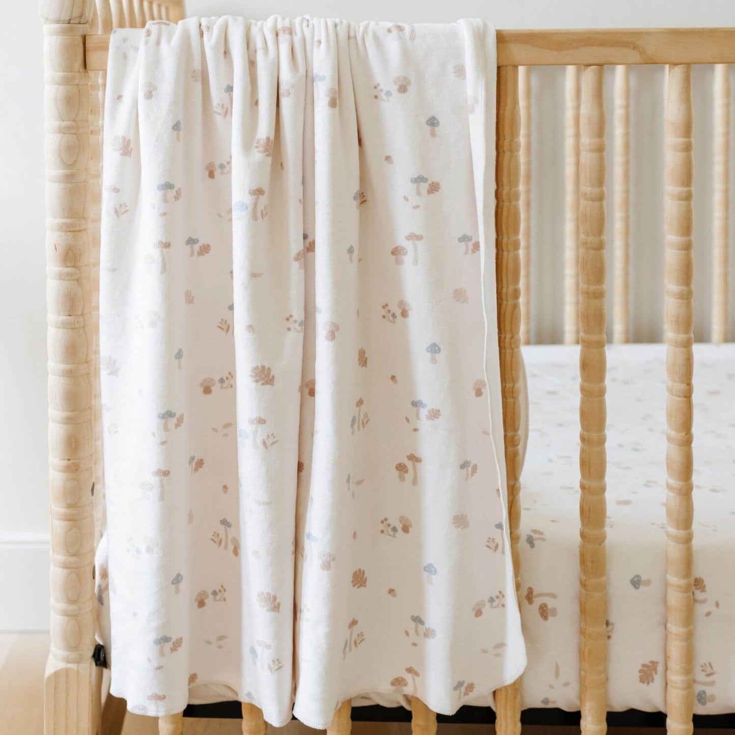 Saranoni Minky Stretch Luxe Crib Sheet Mushrooms hanging on crib