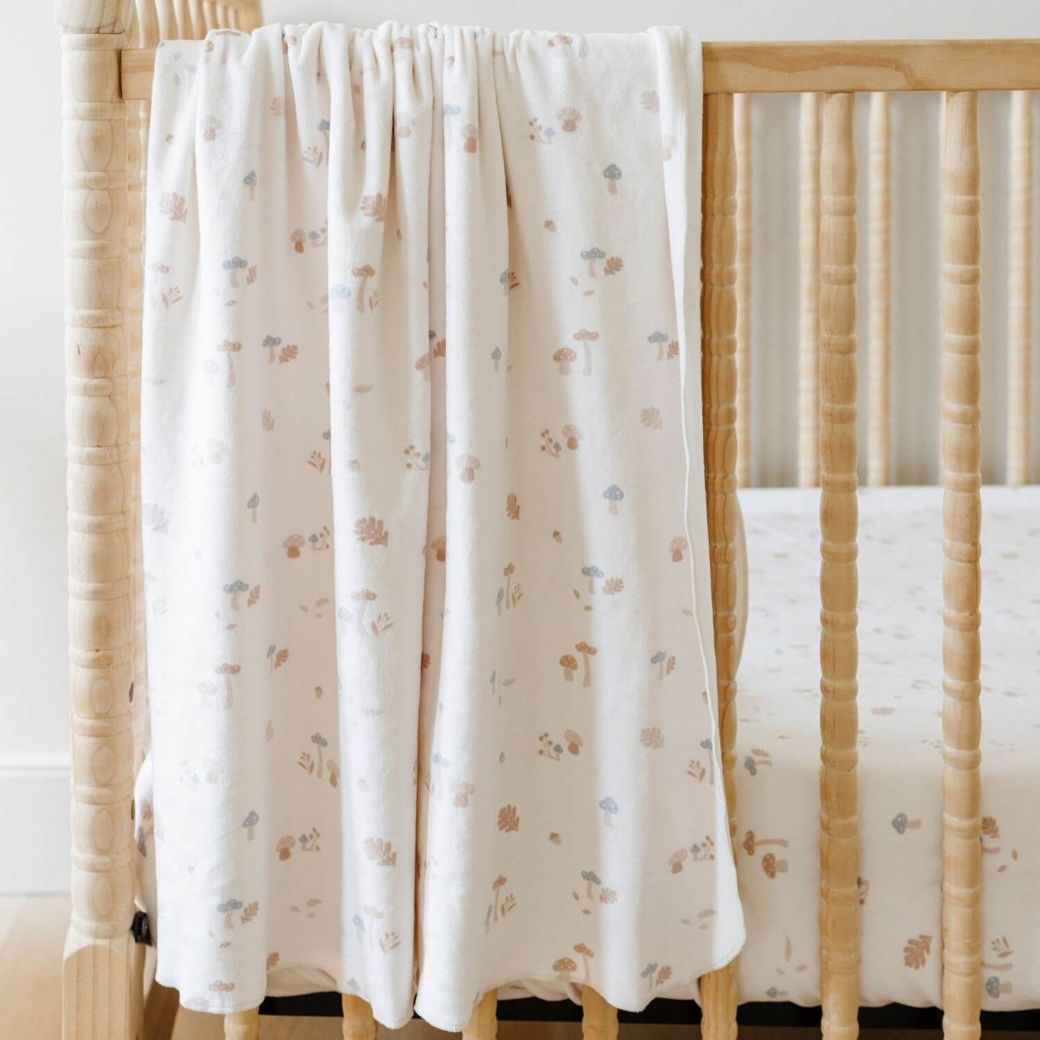 Saranoni Minky Stretch Luxe Crib Sheet Mushrooms hanging on crib