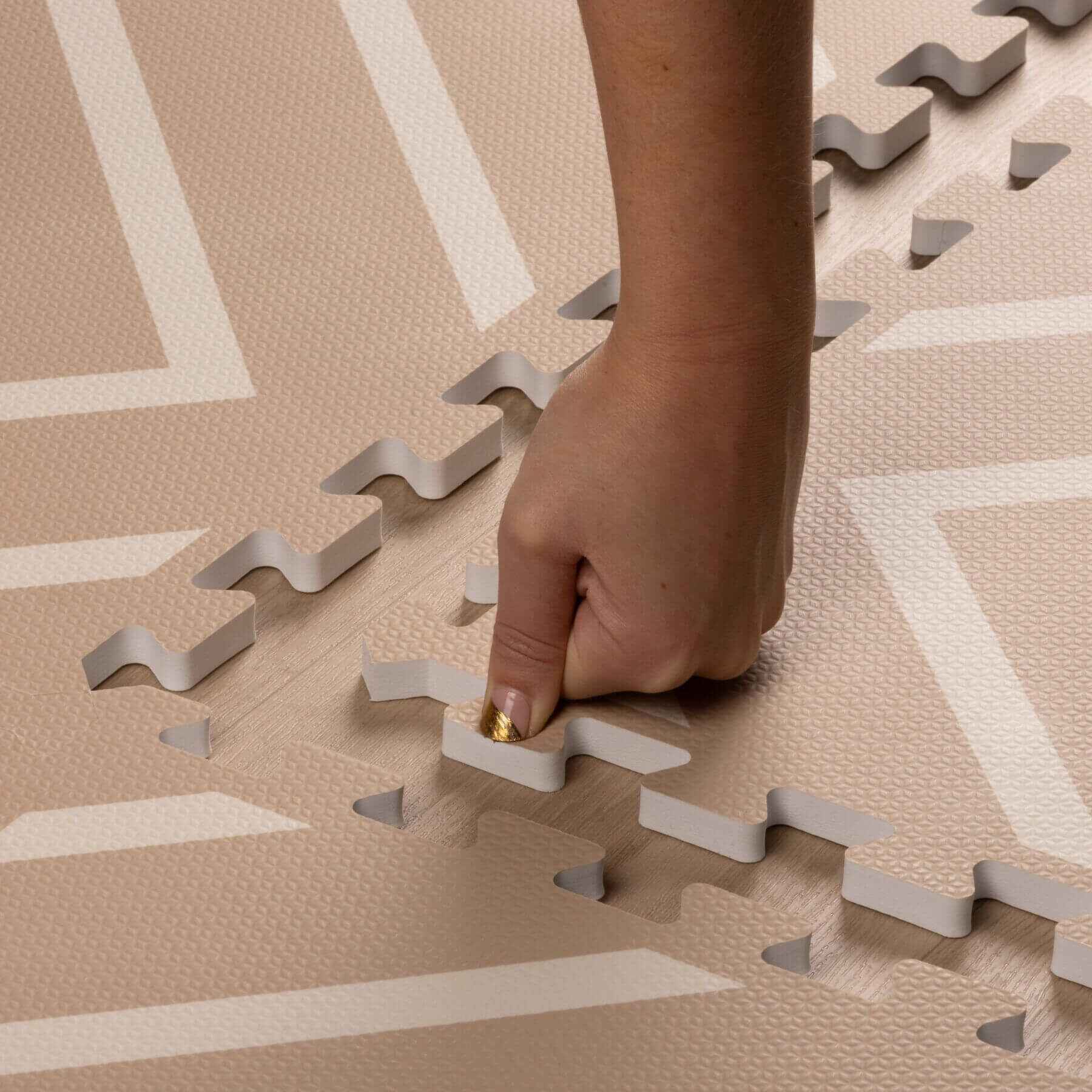 Hand placing Eeveve Modern Blocks Play Mat - Beige