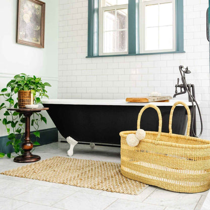 Modern Open Weave African Moses Basket Vegan Handle (No Hood) in Bathroom with a black freestanding bathtub, and plant.