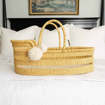 Modern Open Weave African Moses Basket Vegan Handle on a bed