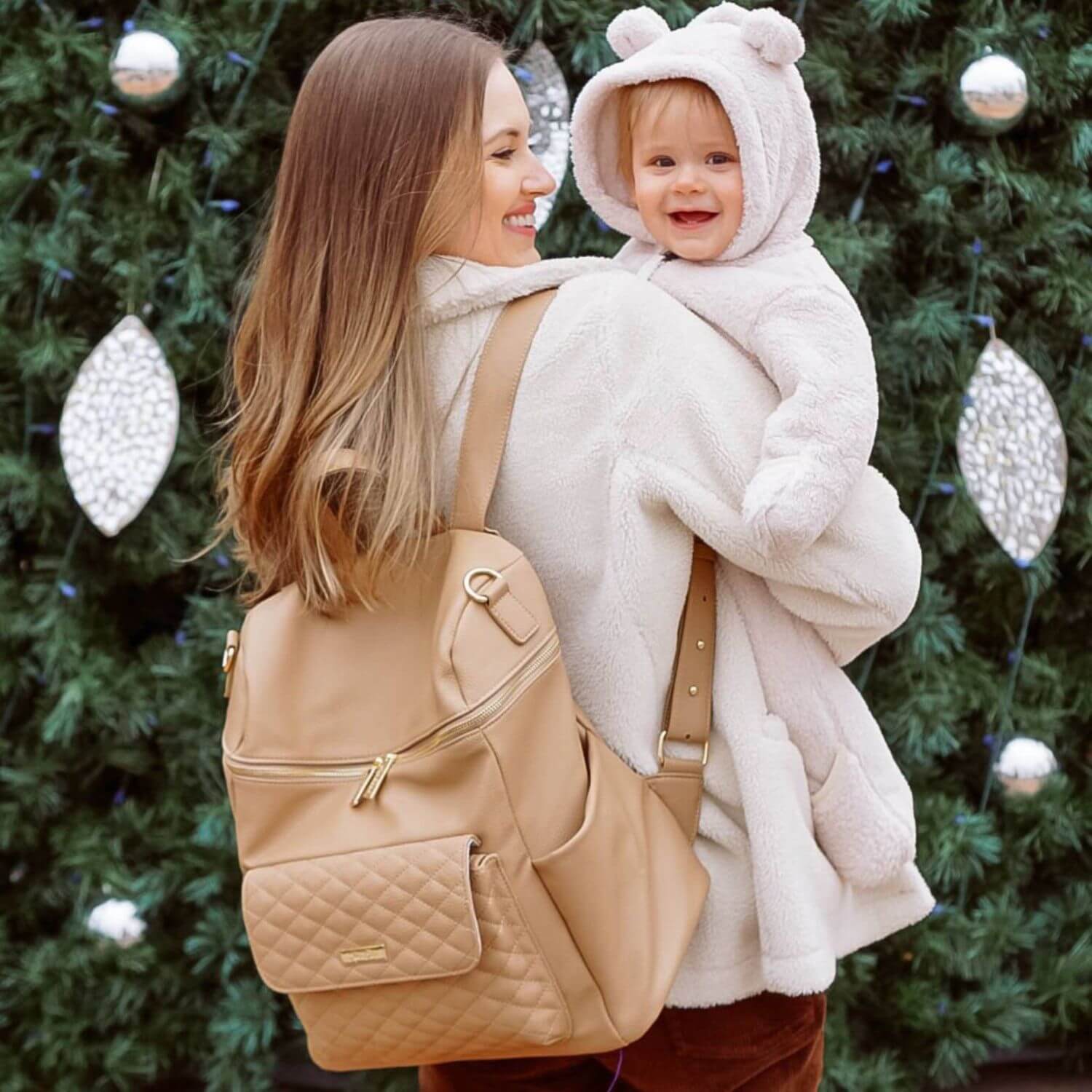 Mom Holding Baby, Carrying Luli Bebé Monaco Diaper Bag | Latte Brown