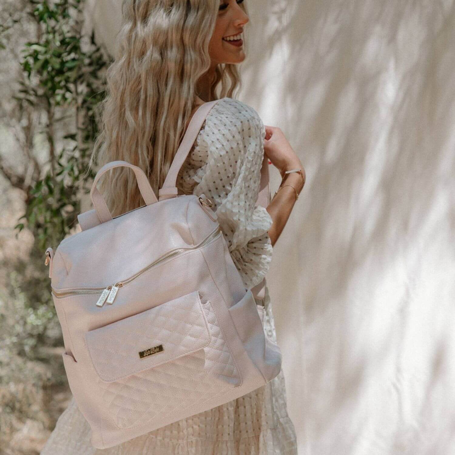 Woman Carrying Luli Bebé Monaco Diaper Bag | Pastel Pink