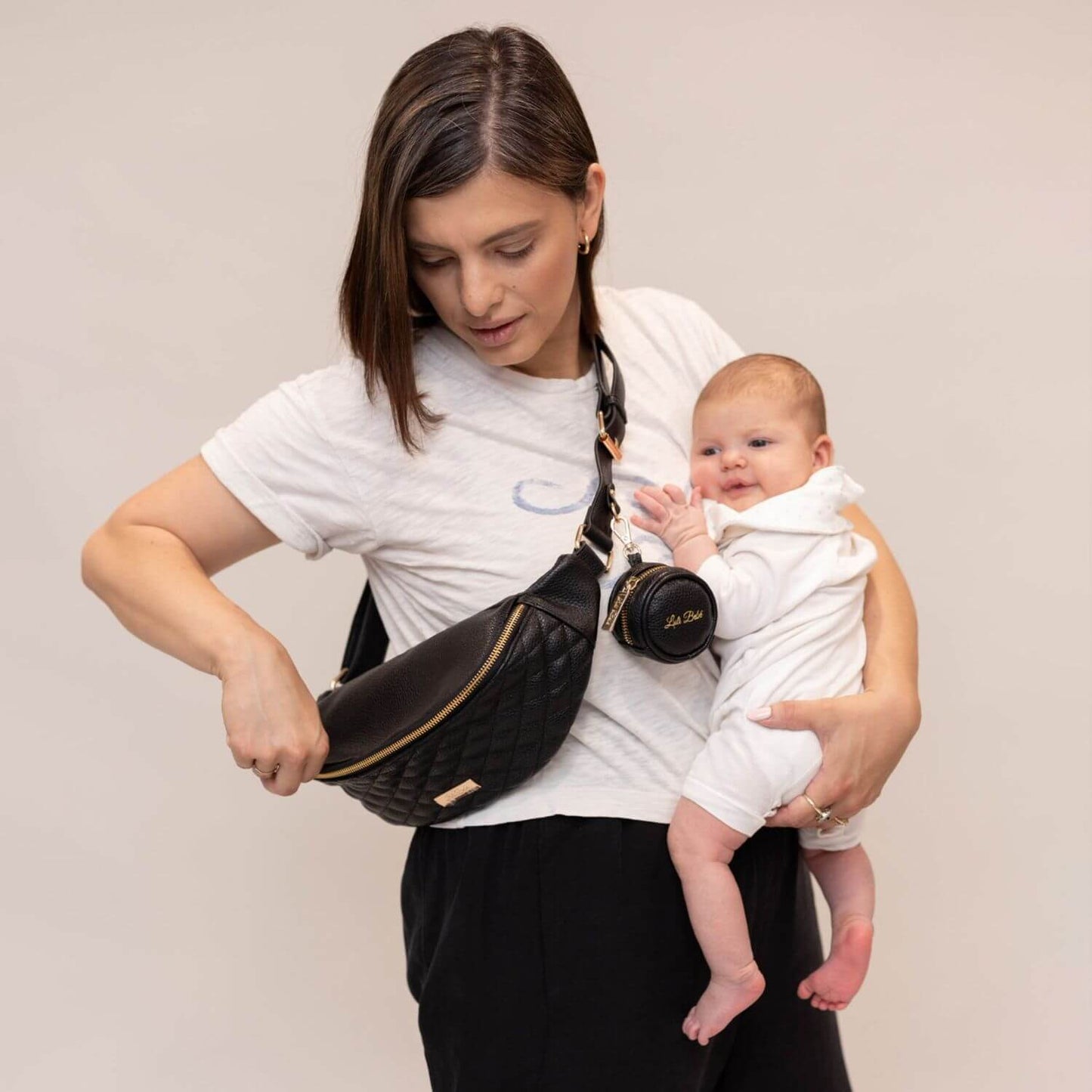 Mom Holding Baby, Carrying Luli Bebé Monaco Sling Bag | Ebony Black