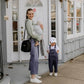 Mom Holding Baby, Carrying Luli Bebé Monaco Snack Bag | Ebony Black