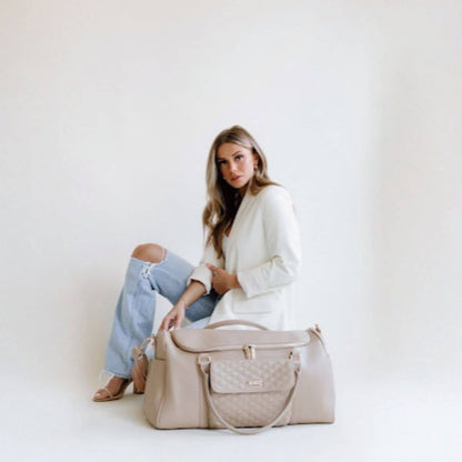 Woman Sitting Behind Luli Bebé Monaco Travel Bag | Latte Brown